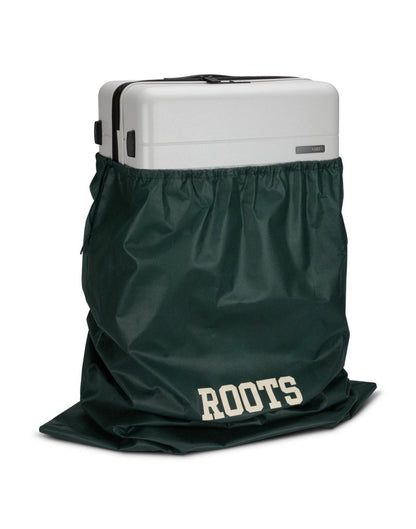 Front angle view of Roots Travel 28" Expandable Hardside Spinner in antarctica, placed inside a Roots bag.