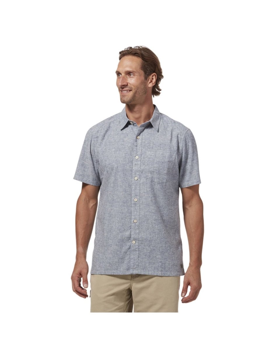 Top half of man wearing Royal Robbins Men's Hempline Short Sleeve in Sea colour with khaki shorts