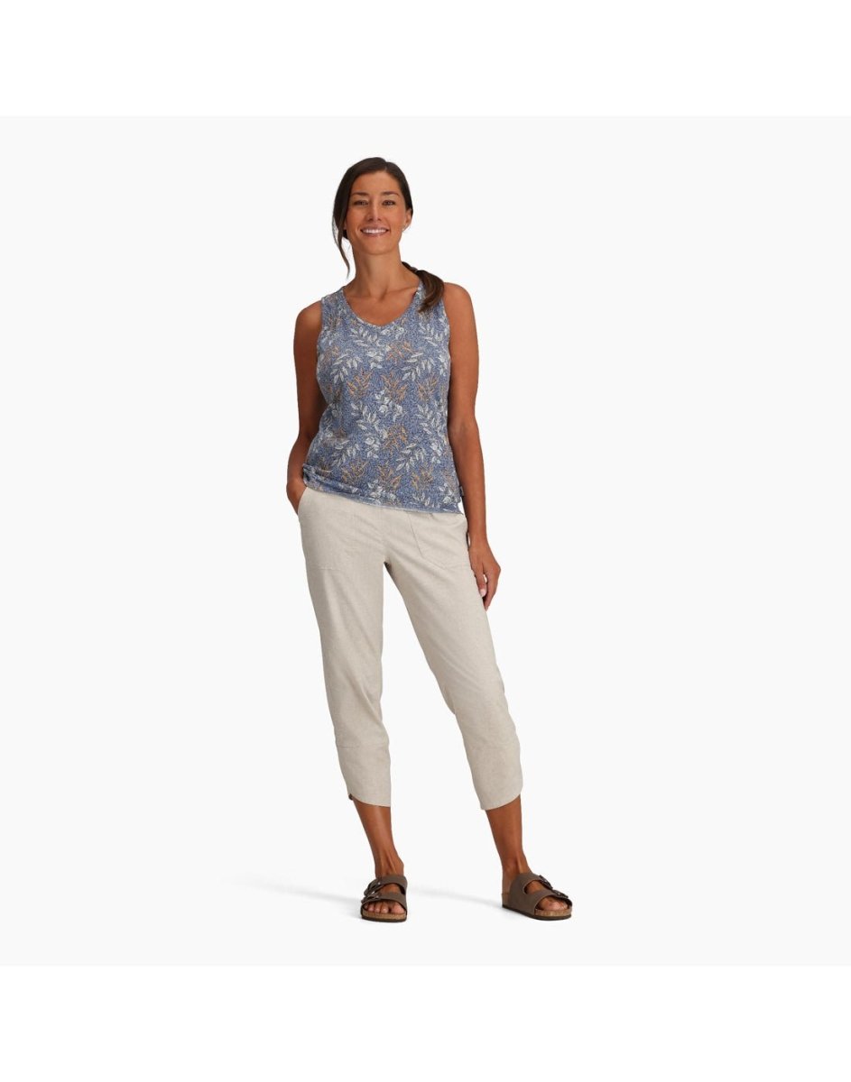 Woman wearing Royal Robbins Women's Featherweight Tank in chicory blue usla print, and khaki pants and sandals, front view with one hand in pocket