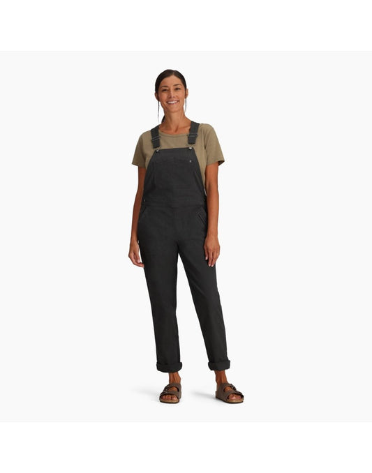 Product Image – Woman wearing Royal Robbins Women's Half Dome Overall in charcoal grey over a khaki t-shirt.  Bottom of pants are rolled up and she is wearing sandals, front view