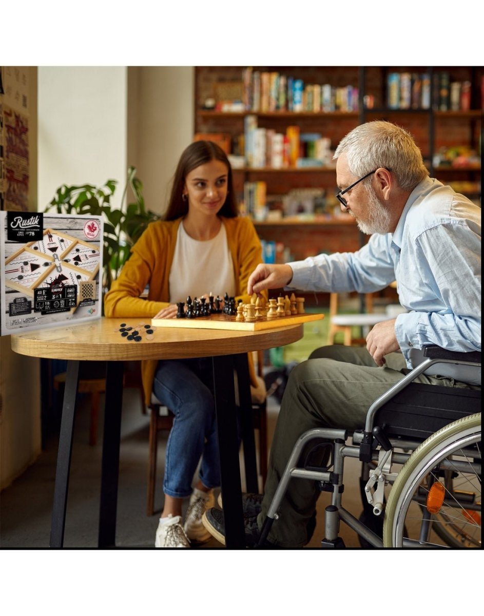 Man in wheelchair and young girl playing Rustik Crazy 4 Sling Puck Game at a table