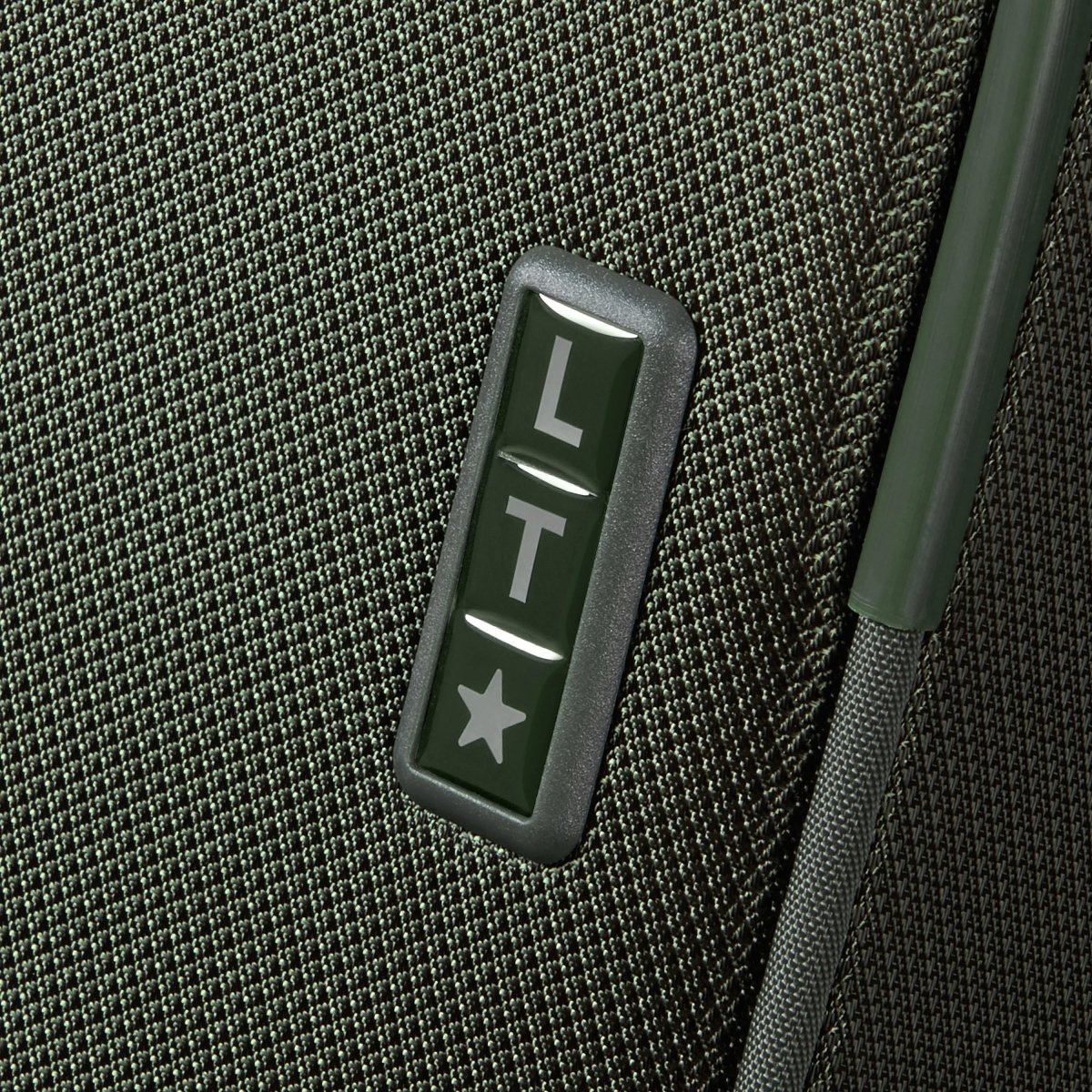 Close-up of a green Samsonite Re-Lite Spinner Large with textured finish and brand details on a dark green panel.