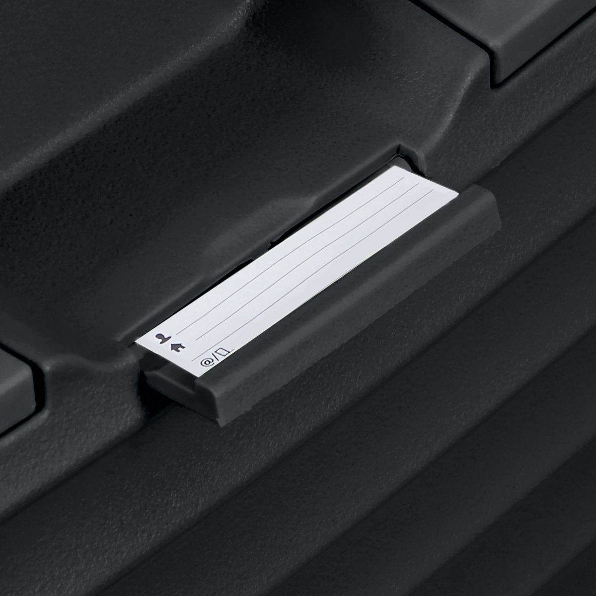 A close-up of the Samsonite Upscape Spinner Carry-On™ label in a black holder, ideal for lightweight travel.