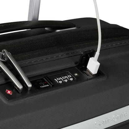 Close-up of Samsonite Upscape Spinner Carry-On™ lock with USB port, shock-absorbing wheels, and logo.