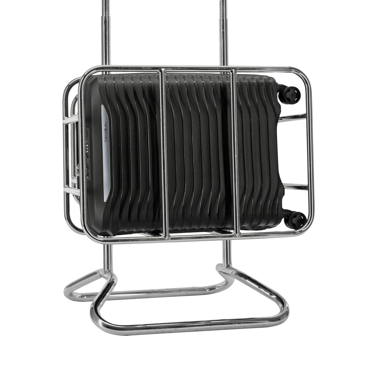 A black Samsonite Upscape Spinner Carry-On™ rests on a chrome metal luggage rack.