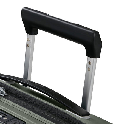 Close-up of Samsonite Upscape Spinner Carry-On™ extended handle and zippers on green lightweight luggage.