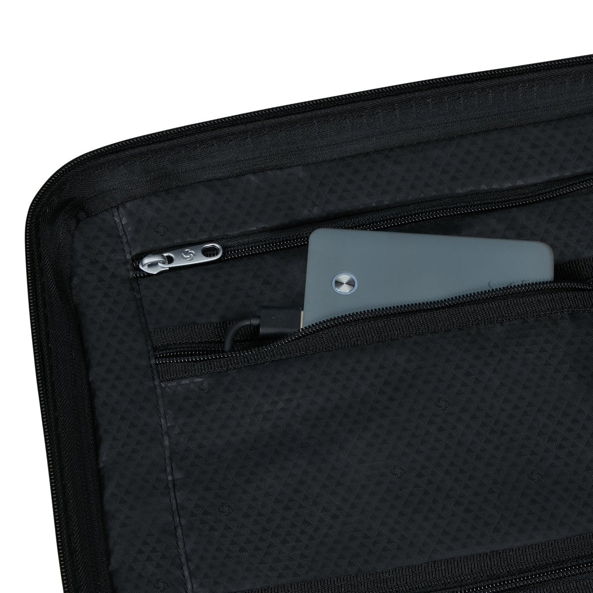 A close-up of the Samsonite Upscape Spinner Carry-On™ reveals a tablet in its inner pocket.