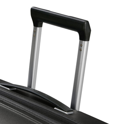 Close-up of the extended telescopic handle on the Samsonite Upscape Spinner Large black suitcase.