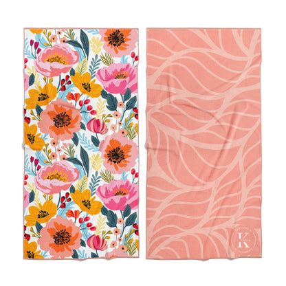 Two K5 microfibre beach towels: one floral, one pink abstract—ultra-absorbent and quick-drying.