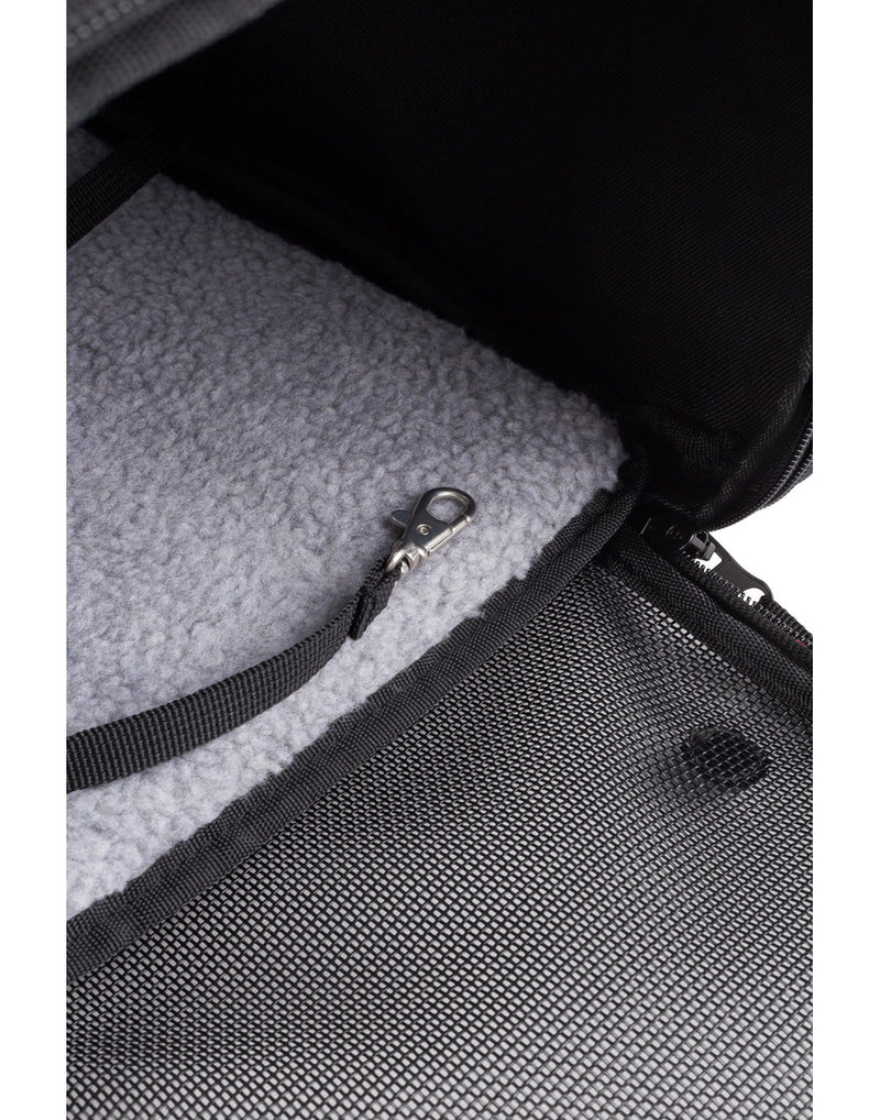 Swiss Gear Carry-on Pet Carrier close up of inside clip and soft fuzz on ground.