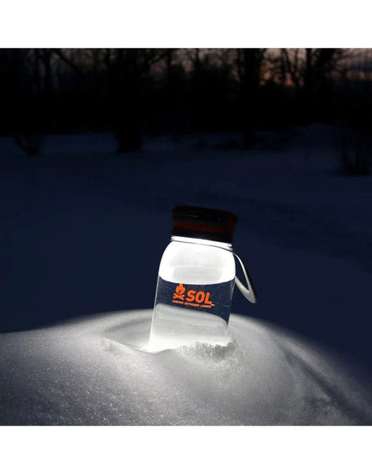 Product Image – SOL Venture Solar Water Bottle Lantern lit and stuck in snowbank