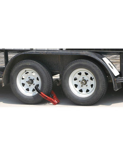 Lifestyle image of The Club® Tire Claw XL affixed to a double wheeled trailer