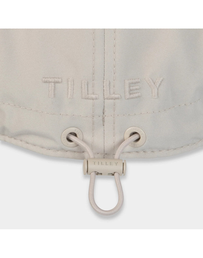 Close up of light stone Tilley Airflo Cap back adjustment cord with Tilley logo embroidered above