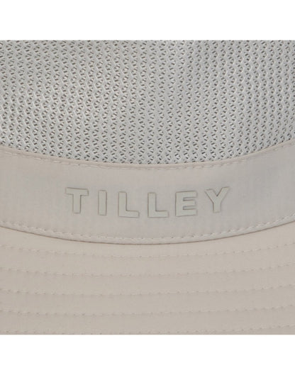 Close up of Tilley logo and ventilation panel on crown of Tilley LTM1 Airflo® Bucket in light stone