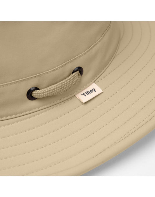 Product Image – Close up of Tilley LTM6 AIRFLO® Hat, khol, brim with Tilley tag and black rivets and windcord strung through crown