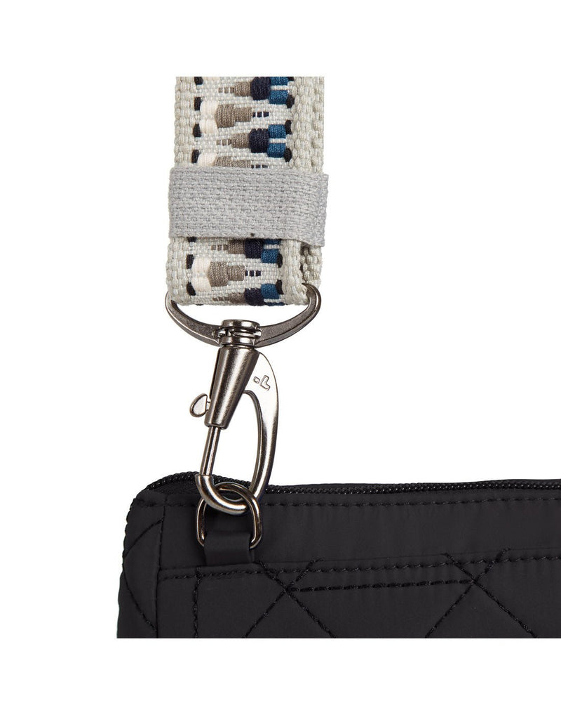 Close up of detachable woven tan guitar strap style crossbody strap on black bag