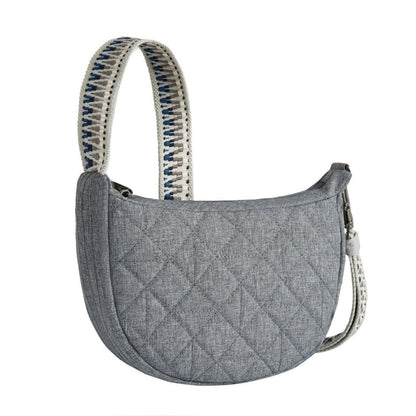 Travelon Boho Anti-Theft Crescent Crossbody in grey with tan, black and blue guitar strap style crossbody strap, front angled view