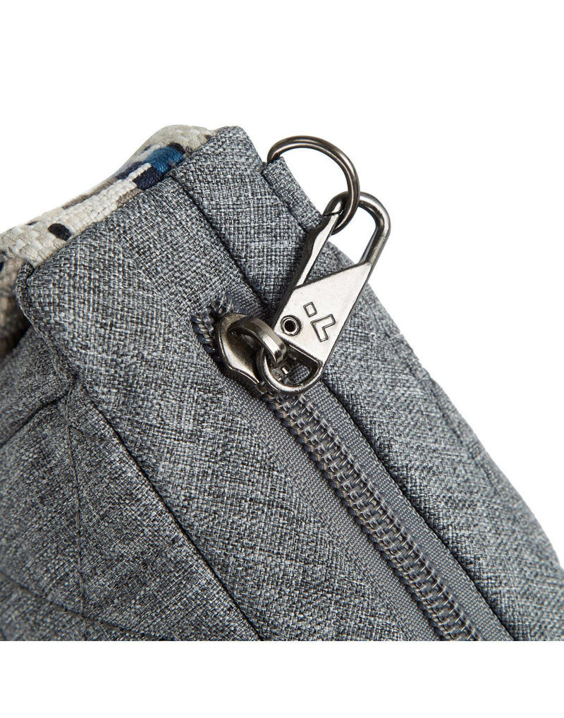Close up of silver metal security clip on zipper pull of grey Travelon Boho Anti-Theft Crescent Crossbody