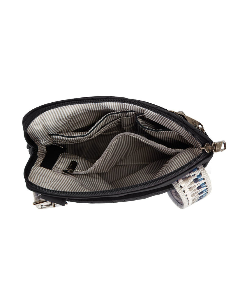 Interior view of the Travlon Boho Anti-Theft Slim Crossbody in black showing the main compartment's slip pockets, zippered pocket and pen loop.