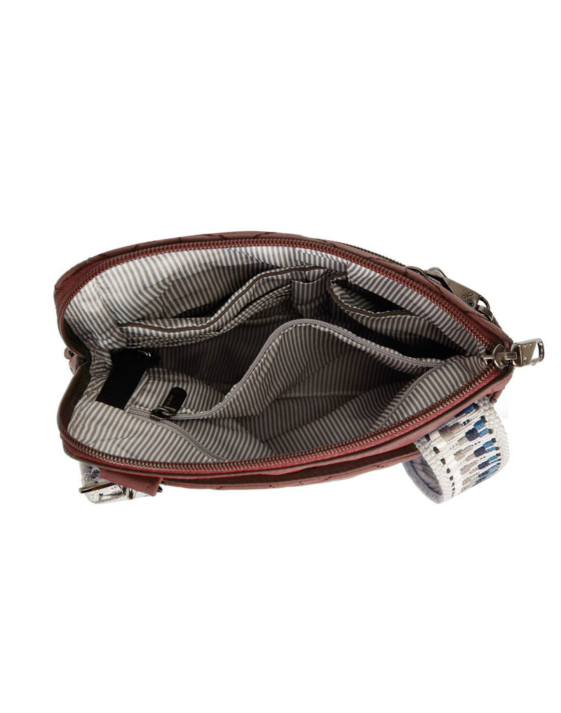 Interior view of the Travlon Boho Anti-Theft Slim Crossbody in Paprika showing the main compartment's slip pockets, zippered pocket and pen loop.