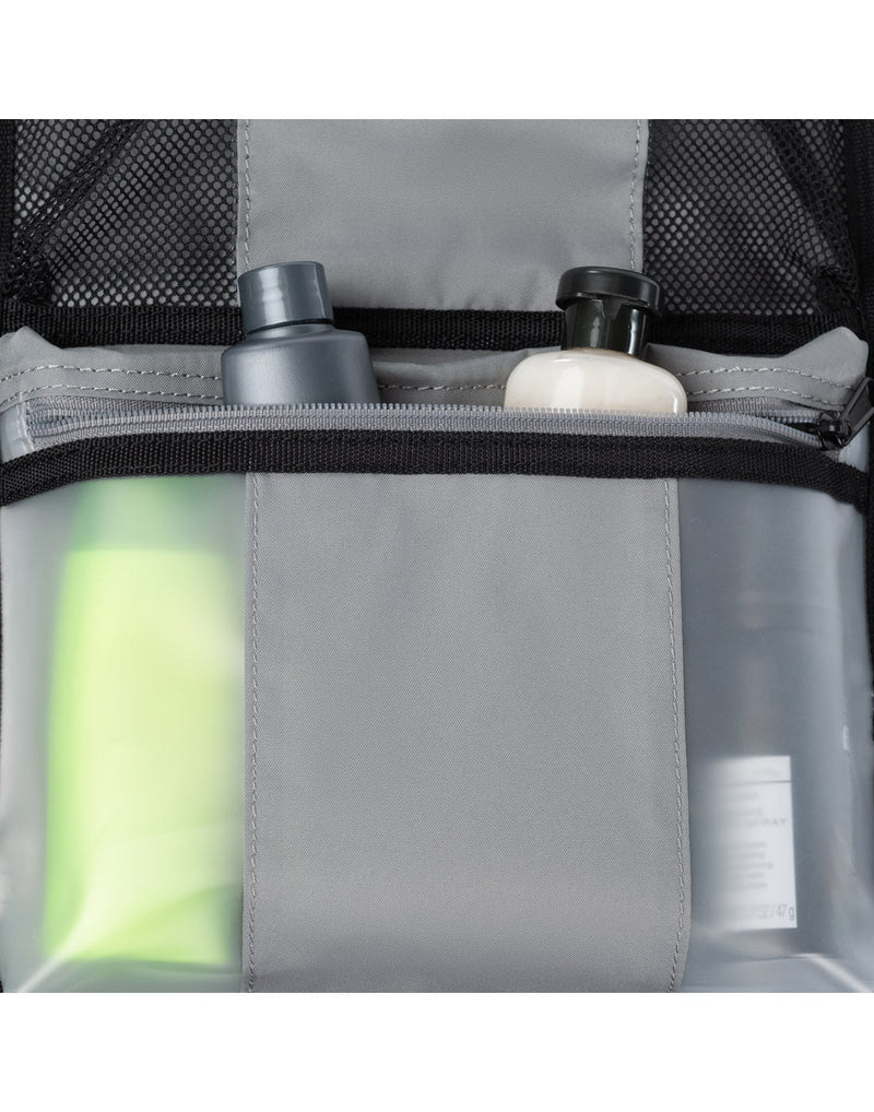 Close up of detachable organizer pouch with various bottles of toiletries inside