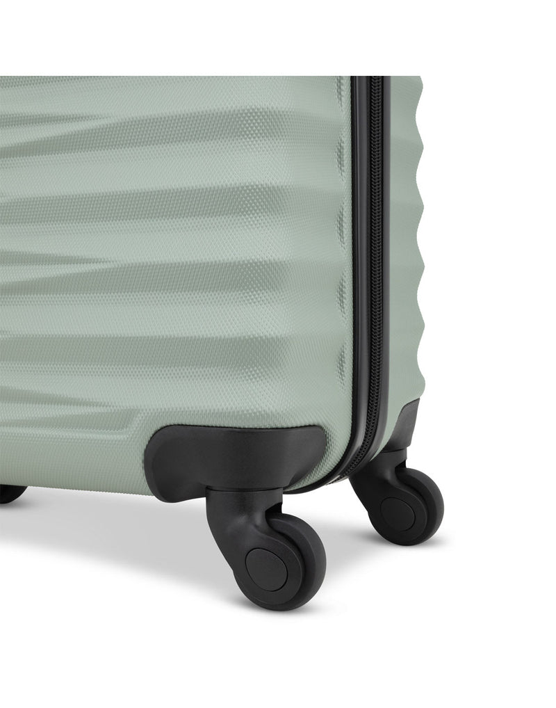 Close up of black spinner wheels on seagrass Atlantic Chaser Hardside 19" Spinner Carry-on
