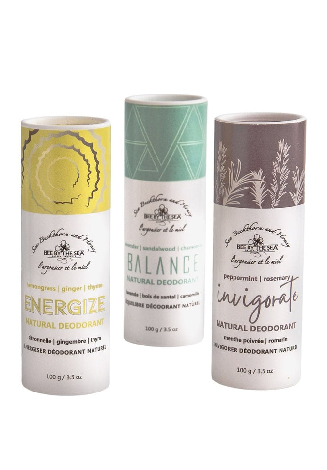 Three tubes of natural deodorant side by side, energize with yellow top, balance with turquoise top, and invigorate with purple top