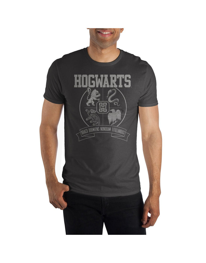 Man wearing charcoal heather t-shirt with Hogwarts house symbols and school name, also features Hogwarts motto, Draco Dormiens Nunquam Titillandus