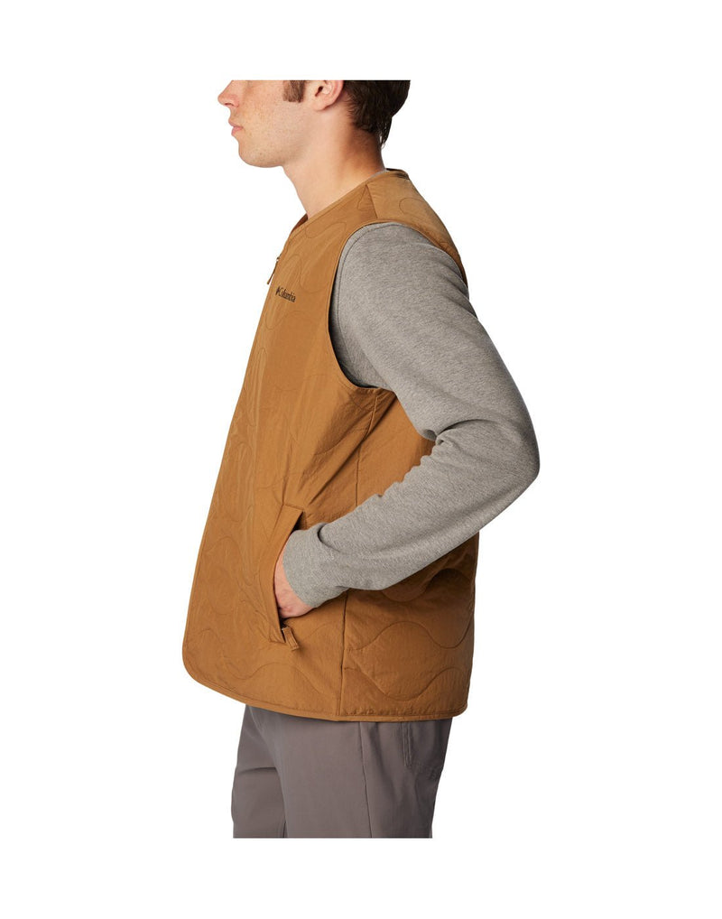 Left side view of a man wearing the Columbia Men's Birchwood™ Vest in Delta brown colour.