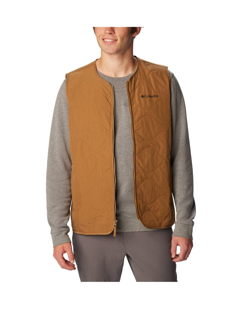 Front view of a man wearing the Columbia Men's Birchwood™ Vest in Delta brown colour. Unzipped.