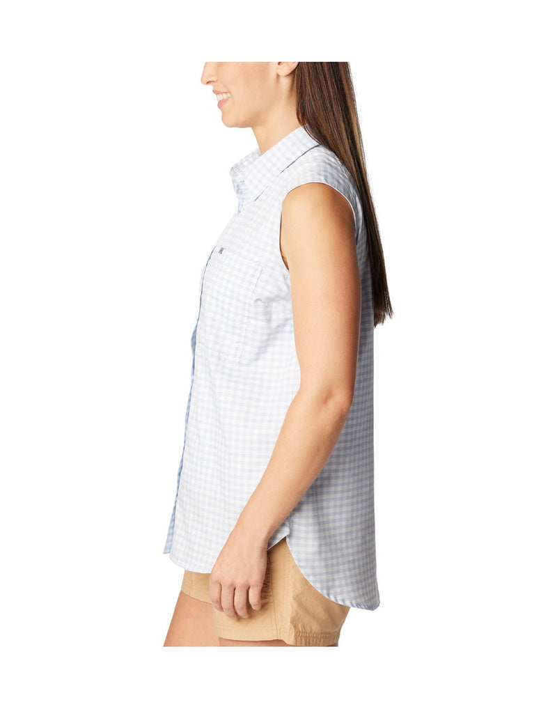 Woman wearing beige shorts and Columbia Women's Anytime™ Lite Sleeveless Top in whisper light blue and white checkered pattern, side view