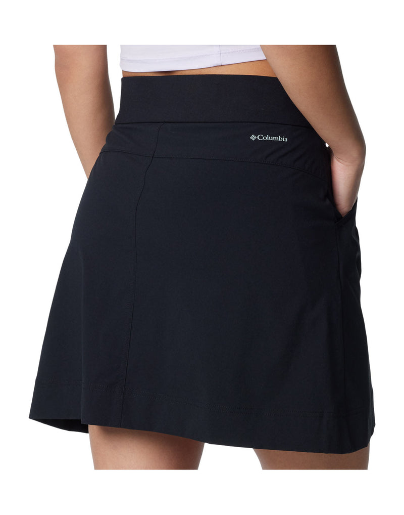 Close up of woman wearing Columbia Women's Anytime™ Straight Skort in black with one hand in pocket, back view