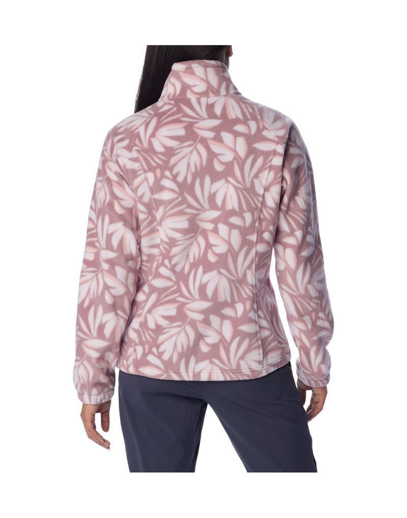 Woman wearing navy blue pants and Columbia Women's Benton Springs™ Printed Full Zip Fleece Jacket in fig areca, pink with white floral pattern, back view
