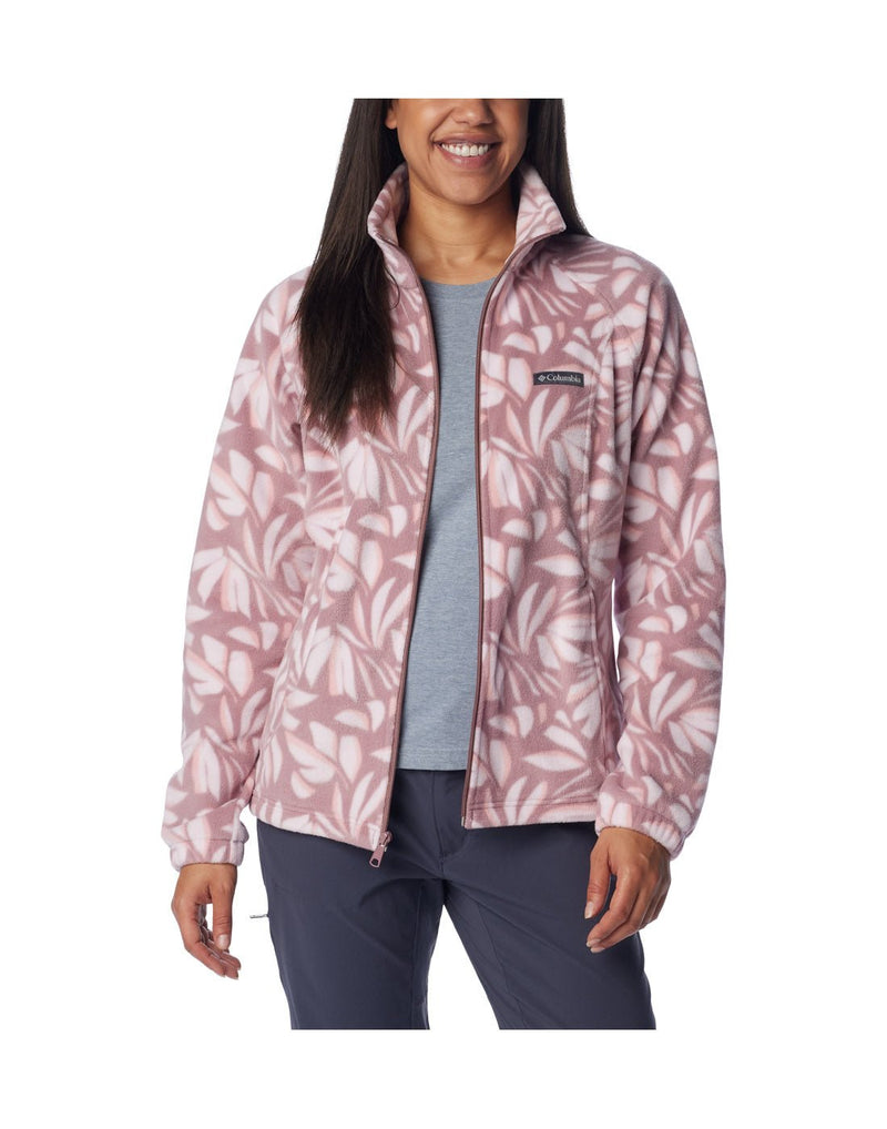 Woman wearing Columbia Women's Benton Springs™ Printed Full Zip Fleece Jacket in fig areca pattern, front view, unzipped, with grey t-shirt beneath