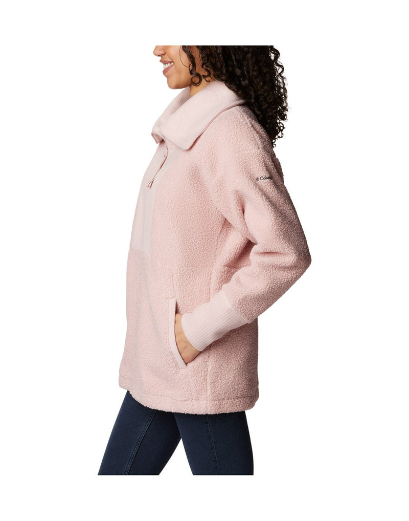 Left side view of a woman wearing the Columbia Women's Boundless Trek™ Fleece Full Zip Jacket in Dusty Pink.