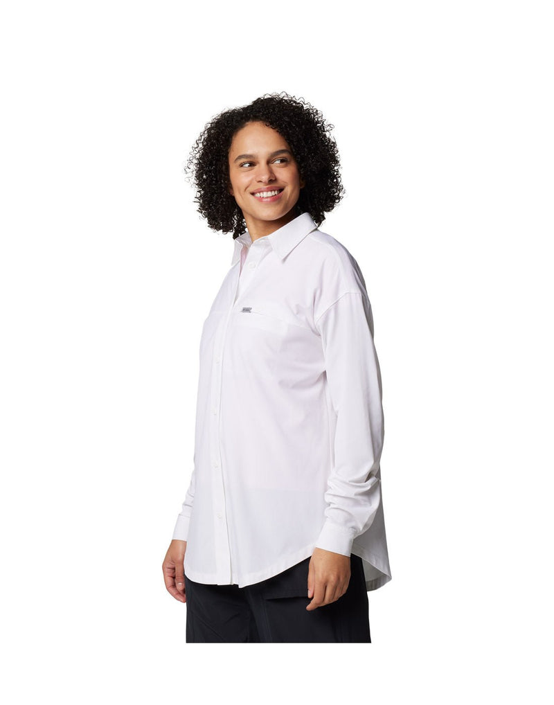 Woman wearing black pants and Columbia Women's Boundless Trek™ Layering Long Sleeve Shirt in white, front angled view