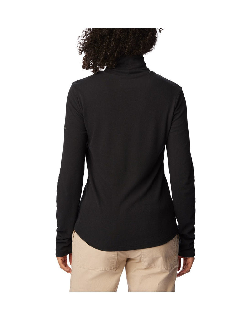 Back view of a woman wearing the Columbia Women's Boundless Trek™ Ribbed Turtleneck Long Sleeve Shirt in black.