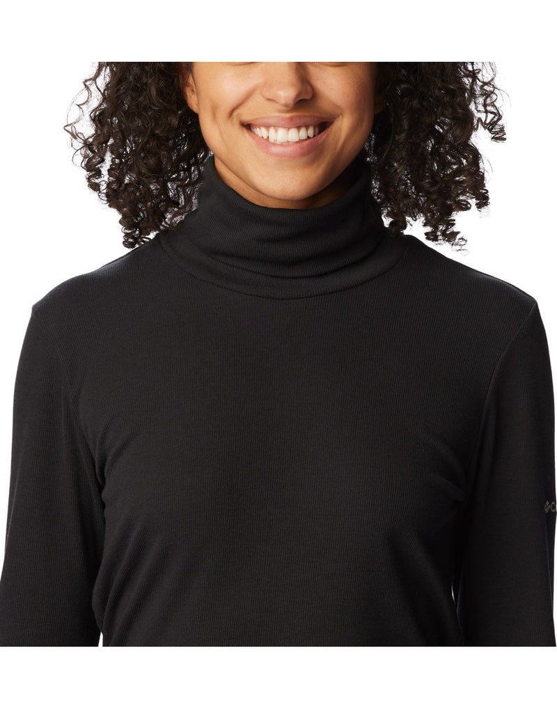 Close-up front view of a woman wearing the Columbia Women's Boundless Trek™ Ribbed Turtleneck Long Sleeve Shirt in black.