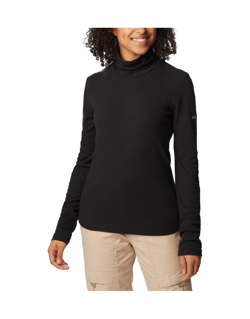 Front view of a woman wearing the Columbia Women's Boundless Trek™ Ribbed Turtleneck Long Sleeve Shirt in black.