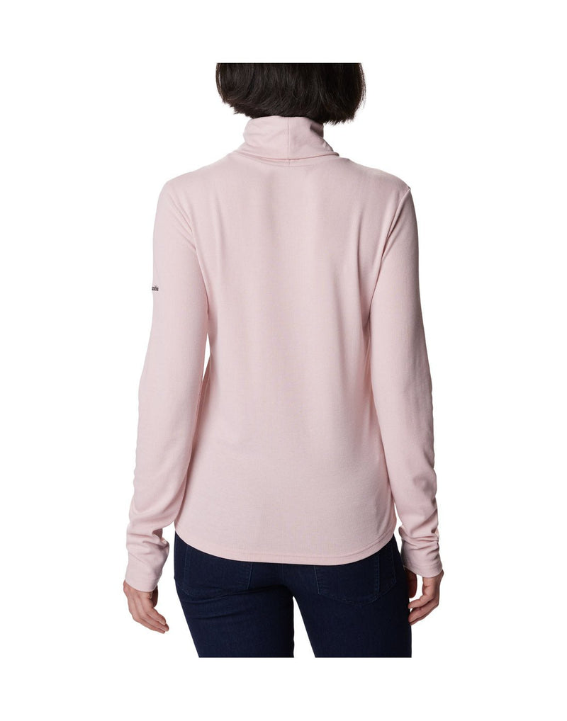 Back view of a woman wearing the Columbia Women's Boundless Trek™ Ribbed Turtleneck Long Sleeve Shirt in Dusty Pink.