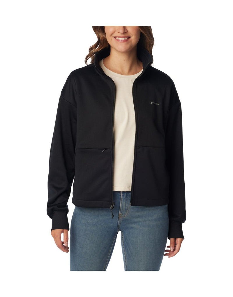Woman wearing blue jeans and Columbia Women's Boundless Trek™ Tech Full Zip Jacket in black, unzipped, front view