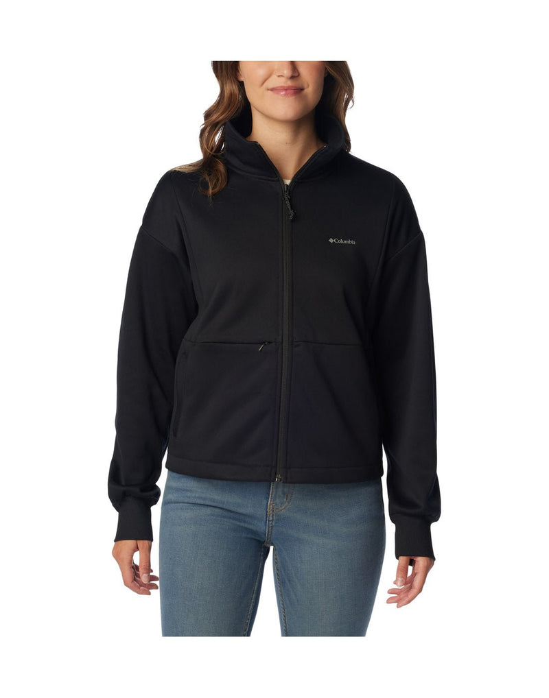 Woman wearing blue jeans and Columbia Women's Boundless Trek™ Tech Full Zip Jacket in black, zipped up, front view