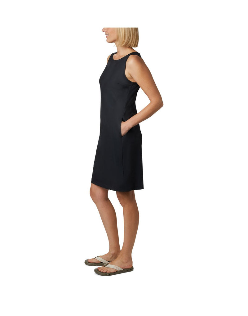 Left side view of a woman wearing Columbia Women's Chill River™ Printed Dress in black with hand in side pocket.