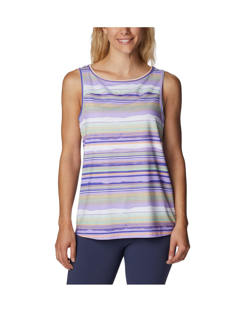 Woman wearing indigo colour pants and Columbia Women's Chill River™ Tank in purple, white and pink stripes, front view
