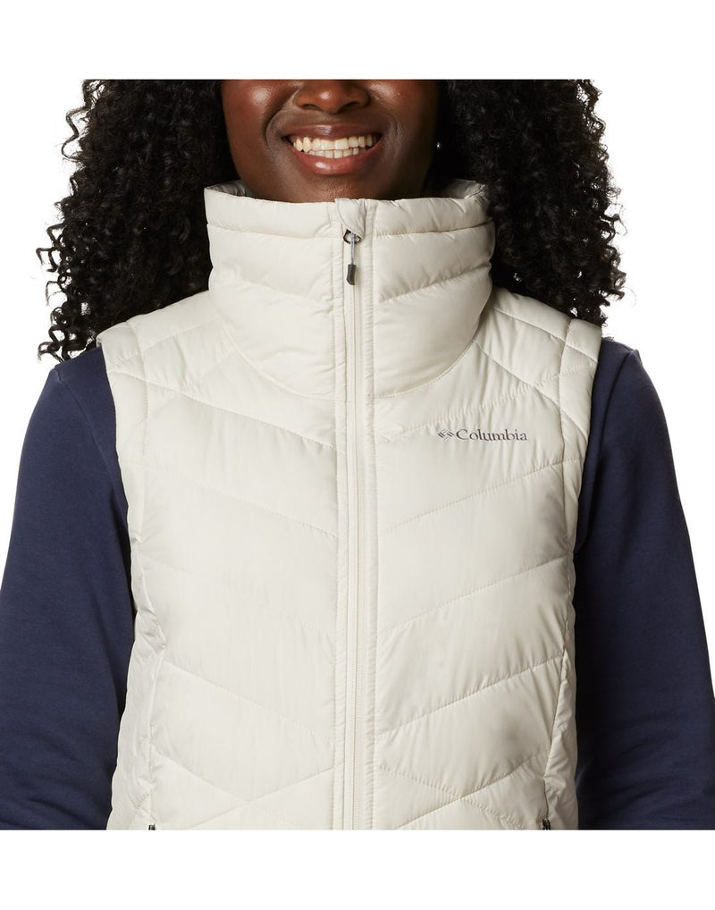 Close-up front view of a woman wearing a Columbia Women's Heavenly™ Long Vest in Chalk colour.
