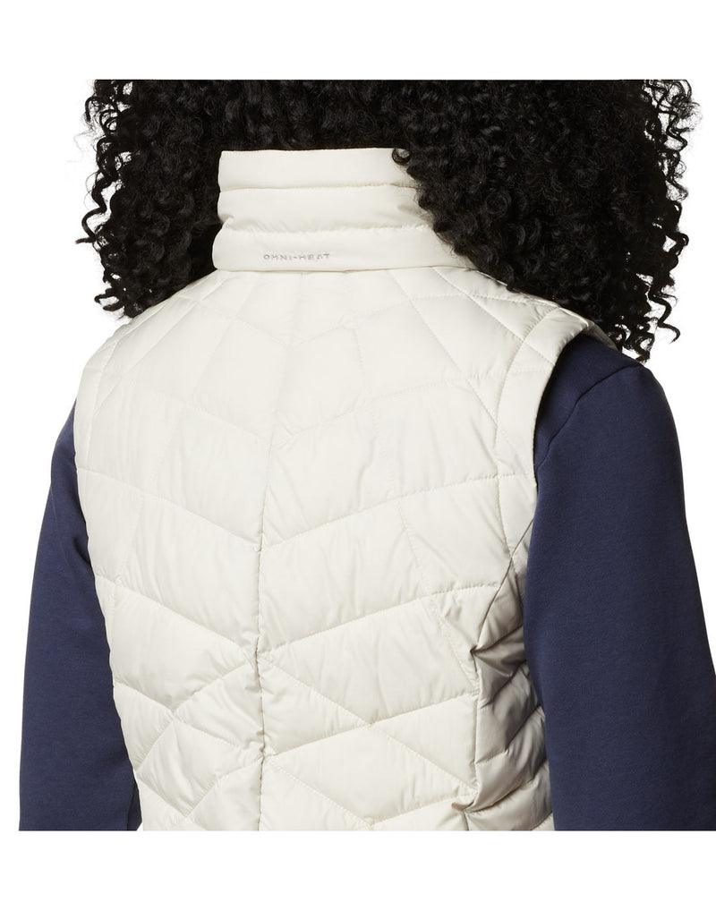 Close-up back view of a woman wearing a Columbia Women's Heavenly™ Long Vest in Chalk colour.