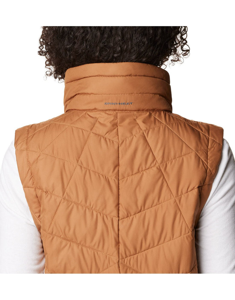 Close-up back view of a woman wearing a Columbia Women's Heavenly™ Long Vest in Camel Brown colour.