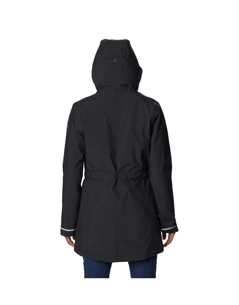 Woman wearing Columbia Women's Here and There™ II Rain Trench in black, back view with hood up