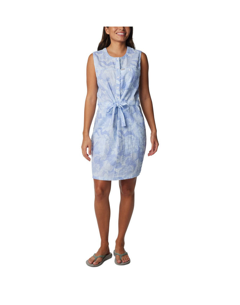 Woman wearing Columbia Women's Holly Hideaway™ Breezy Dress in whisper peonies, blue with white pattern, front view with waist tie in a bow
