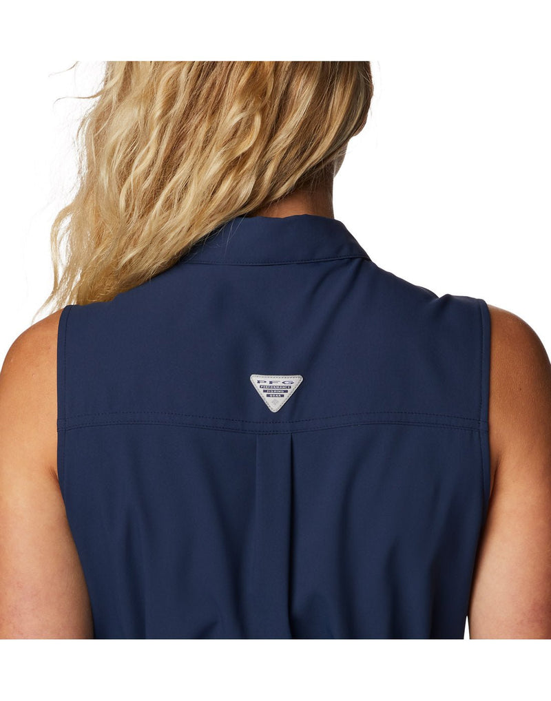 Close up of top half of woman wearing Columbia Women's PFG Sun Drifter™ Woven Dress II in collegiate navy, back view with PFG logo in center of shoulders